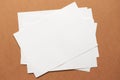 Heap of white empty clean blank paper sheets on cardboard background. Top view, horizontal. Template for poster. Mockup Royalty Free Stock Photo