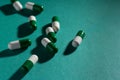 Heap of white and green capsules on green background. Royalty Free Stock Photo