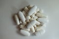 Heap of white magnesium citrate capsules, calcium citrate caplets and vitamin K tablets