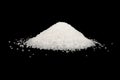 Heap of white sugar isolated on a black background. A pile of powdered white granulated sugar isolated