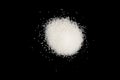 Heap of white sugar isolated on a black background. A pile of powdered white granulated sugar isolated. Top view