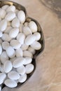 Heap of white sugared almonds in a silver bowl