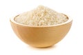 Heap of white uncooked, raw long grain rice in wooden bowl on white