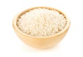 Heap of white uncooked, raw long grain rice in wooden bowl on white