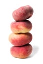 Heap of whole flat peaches stacked on top of each other isolated on white background.