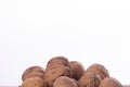 Heap of whole walnuts in shell, side view on white background. Healthy nuts and seeds background. Royalty Free Stock Photo