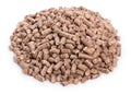 Heap of woody clumps, pellets of litter, for cat, rabbit, guinea pig, hamster, rodent, bird, turtle and other pets, isolated on a Royalty Free Stock Photo