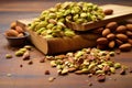 a heaping pile of deshelled pistachios on a wooden board Royalty Free Stock Photo