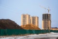 Heaps of chernozem and sand behind fence on building site Royalty Free Stock Photo