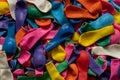 Heaps of colorful balloons background. Plastic deflated balloons for celebrations