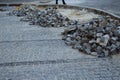 Heaps of paving stones lie on the road, laying stones, unfinished work. road pedestrian area Royalty Free Stock Photo