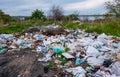 Heaps of plastic trash on the shore of the reservoir. Ecology of nature