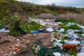 Heaps of plastic trash on the shore of the reservoir. Ecology of nature