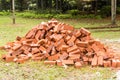 Heaps of red clay bricks at construction site