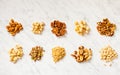 Heaps of various types of nuts on the white marble background Royalty Free Stock Photo