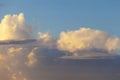 Heapy clouds with warm sunset`s ray. Royalty Free Stock Photo