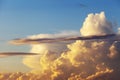 Heapy clouds with warm sunset`s ray. Royalty Free Stock Photo