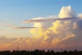 Heapy clouds with warm sunset`s ray. Royalty Free Stock Photo