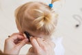 Hearing aid in baby girl`s ear. Toddler child wearing a hearing aid at home. Disabled child, disability and deafness Royalty Free Stock Photo