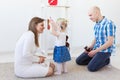 Hearing aid in baby girl`s ear. Toddler child wearing a hearing aid at home. Disabled child, disability and deafness Royalty Free Stock Photo