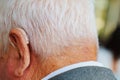 a hearing aid behind the ear of an elderly man. Royalty Free Stock Photo