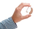 Hearing aid in a man`s hand. Isolated on white background. Royalty Free Stock Photo
