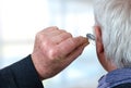 Hearing aid in a senior man