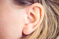 Hearing, health, beauty and piercing concept - close up of woman`s ear Royalty Free Stock Photo