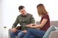 Hearing impaired friends using sign language for communication on sofa Royalty Free Stock Photo