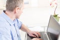 Hearing impaired man working with laptop