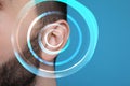 Hearing loss concept. Man and sound waves illustration on light blue background, closeup Royalty Free Stock Photo