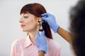 Hearing loss and otitis treatment concept. Close up of female young patient having check up at ENT doctor