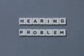 ' Hearing Problem ' word made of square letter word on grey background