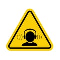 Hearing protection sign. High noise level warning sign. Yellow triangle sign with a human head icon with headphones inside. Wear