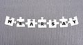 HEARSAY - word composed of paper white puzzles on a gray background Royalty Free Stock Photo