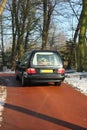 Hearse on a winter cemetery Royalty Free Stock Photo