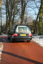 Hearse on a winter cemetery