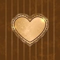 Vintage heart shaped decorative golden frame on striped brown background. Royalty Free Stock Photo