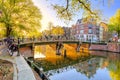 Heart of Amsterdam. Early morning in Amsterdam. Ancient houses, a bridge, traditional bicycles, canals and the sun shines through Royalty Free Stock Photo