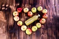 Heart of apples on brown wooden background. Apple juice on wooden table Royalty Free Stock Photo