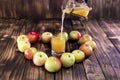 Heart of apples on brown wooden background. Apple juice on wooden table Royalty Free Stock Photo