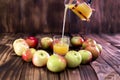 Heart of apples on brown wooden background. Apple juice on wooden table Royalty Free Stock Photo