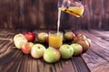 Heart of apples on brown wooden background. Apple juice on wooden table Royalty Free Stock Photo