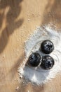 Metallic heart duet container jumbo blueberries on granulated bed of sugar free sweetener on wooden board Royalty Free Stock Photo