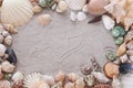 Heart with arrow drawing in sand and seashells.