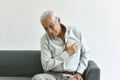 Heart attack disease problem in old man, Elderly asian man with hand on chest gesture.