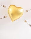 Heart balloon gold with forks all around it trying to poke it. Valentine love hurts concept idea