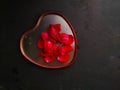 heart with red rose petals on black background representing valentine\'s day Royalty Free Stock Photo