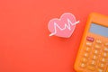 Heart beat and calculator.symbolizing the concept of tracking health expenses or medical costs Royalty Free Stock Photo