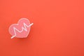Heart beat isolated on a red background.symbolize routine medical check-ups, diagnostics, and the importance of heart health